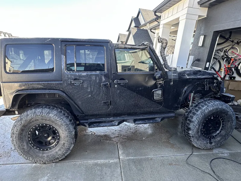 Jeep with its hood open and tools nearby