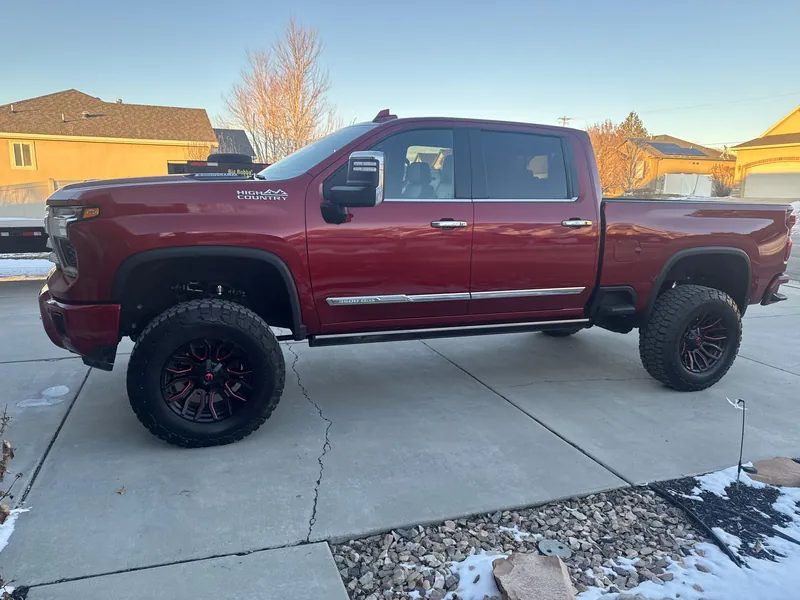 Red crew-cab truck parked in a driveway